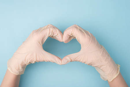 Save life concept. Cropped top above overhead close up photo of hands making giving shape of heart...