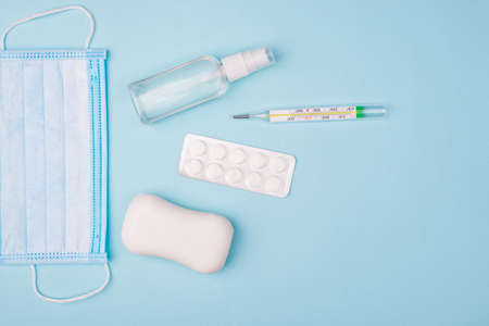 Save yourself. Top above overhead flat lay photo of surgical mask soap blister mercury thermometer and little bottle with spray for hands isolated over background with empty blank copy spaceの写真素材