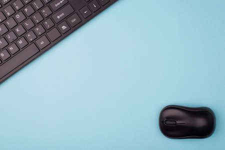 Flat lay flatlay top above overhead close up view photo of black computer wireless mouse and keyboard isolated over blue background with empty blank spaceの写真素材