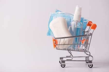 Sale customer purchase epidemic disease medicare concept. Side profile close up photo of shopping basket full of hygiene products isolated grey background with empty blank spaceの写真素材