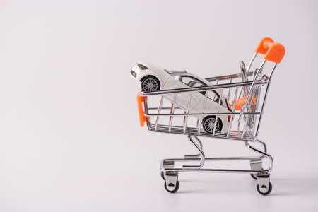 Buy new white car parking tax industry concept. Side profile close up photo of small mini toy car...