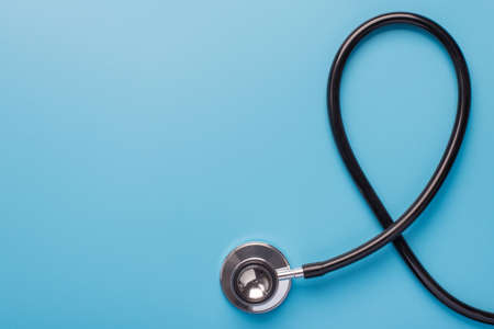 November month charity mental problem research insurance concept. Flat lay top above overhead close up view photo of black stethoscope isolated on blue background with empty spaceの写真素材