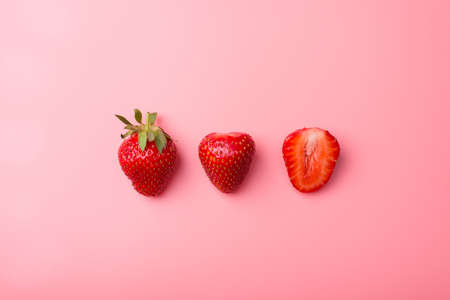 Top above overhead view photo of cut strawberries isolated on pink backgroundの写真素材