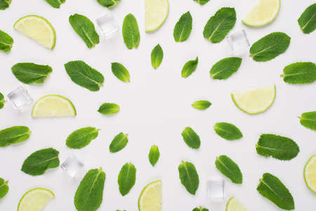 Top above overhead view photo of mint leaves, ice-cubes and lime slices lying in circles with empty center isolated on white backgroundの写真素材