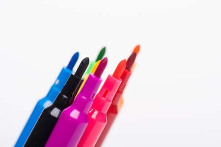 Drawing with markers concept. Close-up cropped photo of markers tips looking up with no caps...
