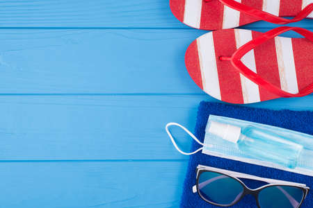 Quarantine and summertime relax concept. Top above overhead view close-up photo of sanitizer mask...