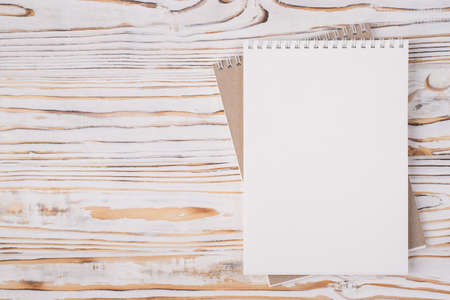 Top above overhead view flat lay photo of a blank notebook placed to the right side isolated on...