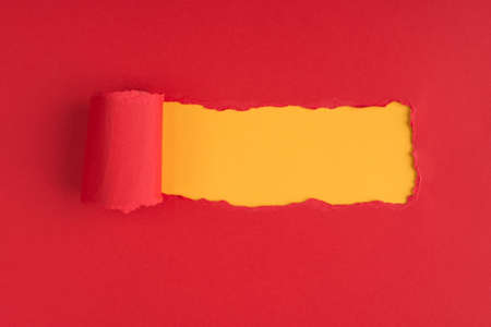 Top above overhead view photo of torn red paper over yellow background with copyspace