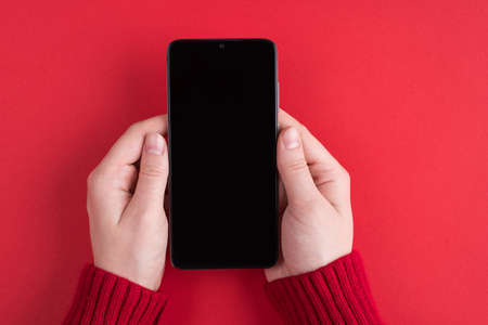 Firts person close up top above overhead close up view photo of female young hands holding using telephone showing blank screen sending greetings isolated over bright color backgroundの写真素材