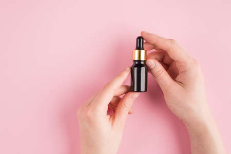 Anti-aging concept. Top above overhead pov first person view photo of female hands holding serum...