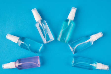 Hands hygiene concept. Top above overhead view photo of sanitizer bottles isolated on blue backgroundの写真素材