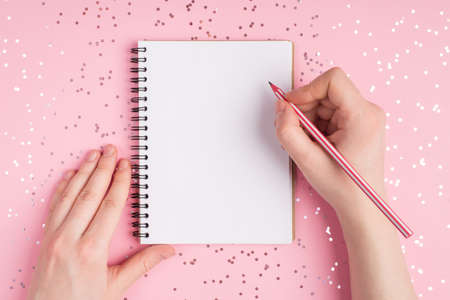 Close up top above overhead first person view photo of teen teenager hands holding pencil and clean...