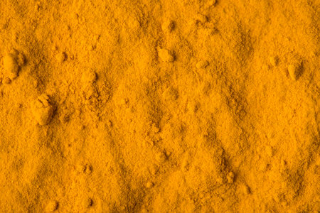 Indian spice turmeric. Close up view photo of textured backdrop of light color curcuma powderの写真素材