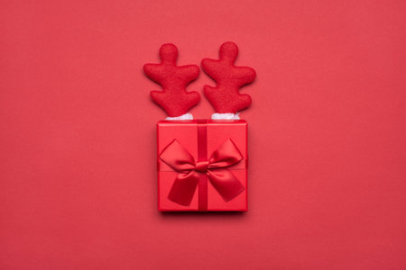 Christmas deer concept. Top view photo of present box with bow and small horns isolated vivid color background tableの写真素材