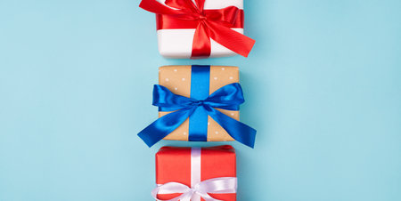 Top above overhead close up view photo of three present boxes with beautiful bows isolated light...