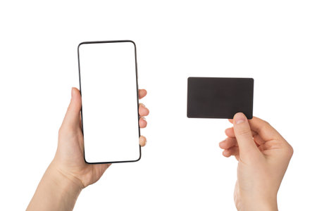 Cyber monday concept. Pov close up view photo of female hands holding smart telephone with blank empty display and black card with bonus certificate isolated white backgroundの写真素材