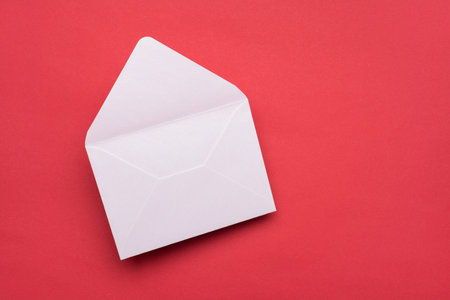Closeup view photo of white open empty envelope isolated red color background