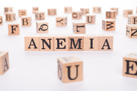 Anemia concept. Close up view photo of wooden cubes making showing word anemia on white tableの写真素材