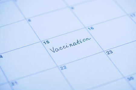 Vaccination concept. Close up view photo of word vaccination written on calendar cellの写真素材