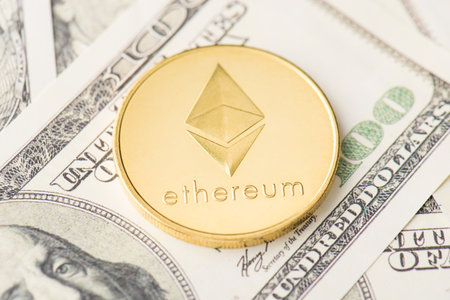 Close up photo of golden shiny glowing ethereum coin lying on american bill money