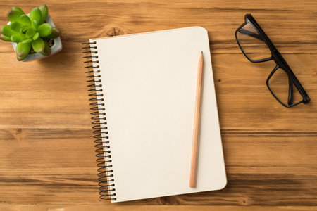 Top above overhead view photo of empty blank notepad on spiral with clear page pencil eyeglasses on...