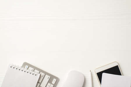Above overhead close up view photo of pc stuff open spiral clear copybook pencil and smart phone...