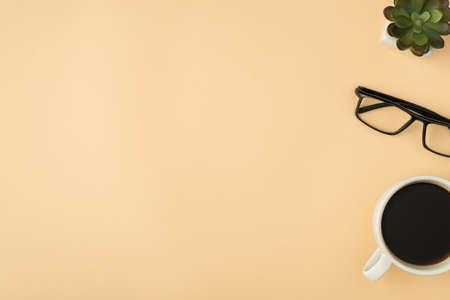 Top view photo of plant glasses and cup of coffee on isolated beige background with copyspaceの写真素材