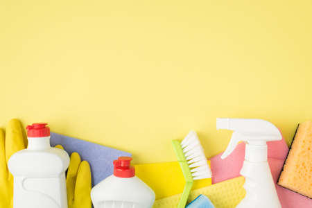 Top view photo of multicolor viscose rags rubber gloves sponges brush spray and gel detergent...