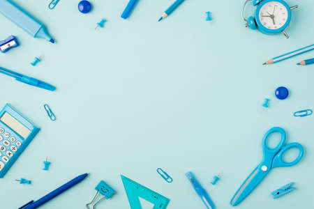 Top view photo of school supplies blue stationery on isolated pastel blue background with copyspace in the middleの写真素材