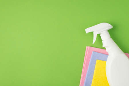Top view photo of white spray detergent bottle without label on multicolor viscose napkinsの写真素材