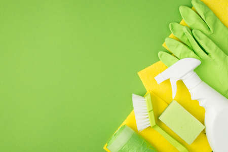 Top view photo of spray detergent bottle without label brush sponge yellow viscose napkins garbage...