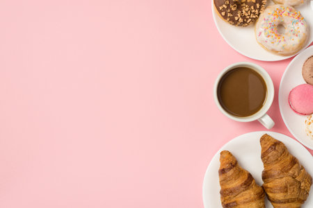 Overhead photo of various pastry glazed donuts croissants macaroons and cup of coffee isolated on...
