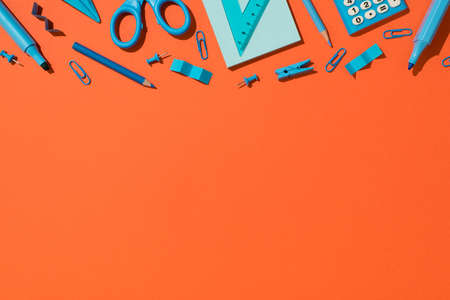 Top view photo of blue school accessories stationery markers pencils scissors pins clips sticky note...