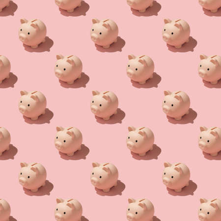 Top view photo of piggy banks pattern on isolated pastel color pink backgroundの写真素材