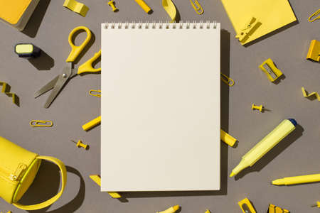 Top view photo of spiral notebook yellow stationery school supplies scissors felt pens sticky note...