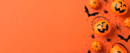 Top view photo of halloween decorations pumpkin baskets spiders bat silhouettes and violet sequins...