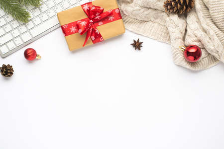 Top view photo of gift box with red bow keyboard red christmas tree balls pine twig cone anise and...