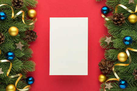 Top view photo of paper sheet gold and blue christmas tree balls pine cones glowing stars and gold...