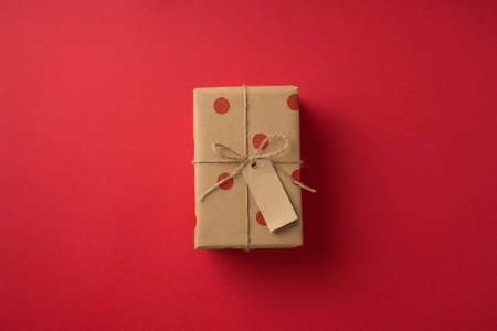 Top view photo of saint valentine's day decorations kraft paper giftbox with polka dot pattern and...