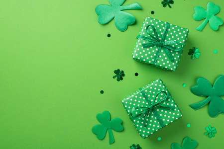 Top view photo of st patrick's day decorations two green gift boxes with polka dot pattern clover...
