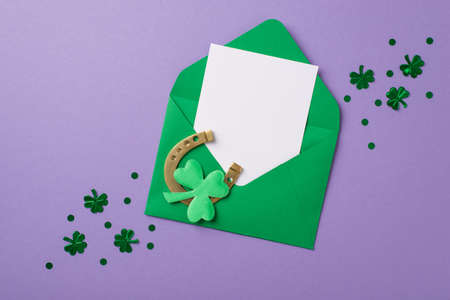 Top view photo of st patricks day decorations shamrock shaped confetti green envelope with paper...