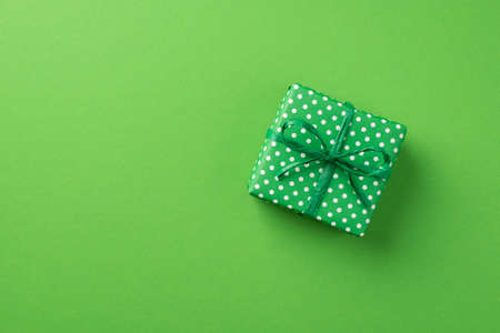 Top view photo of st patrick's day decorations green giftbox with polka dot pattern on isolated pastel green background with copyspaceの写真素材