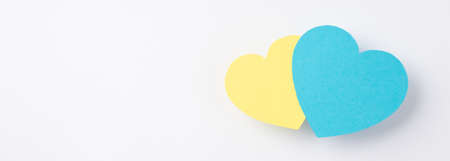 Stop the war in Ukraine concept. Top view photo of national flag colors two yellow and blue hearts...