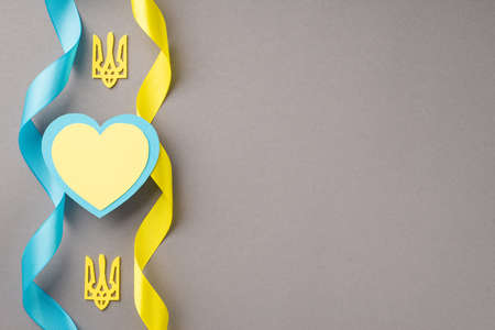 Stop the war in Ukraine concept. Top view photo of golden tridents national flag colors yellow and...