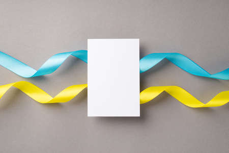 Stop the war in Ukraine concept. Top view photo of paper sheet over national flag on isolated gray...
