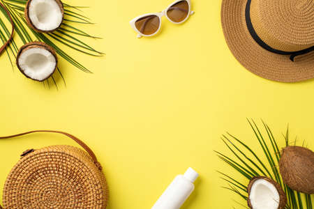 summer concept. Top view photo of hat round rattan bag sunglasses sunscreen bottle cracked coconuts...