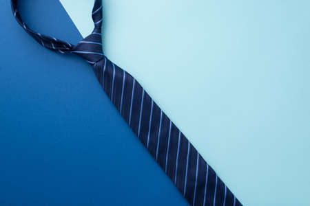 father's day concept. Top view photo of blue necktie on bicolor blue background with copyspaceの写真素材