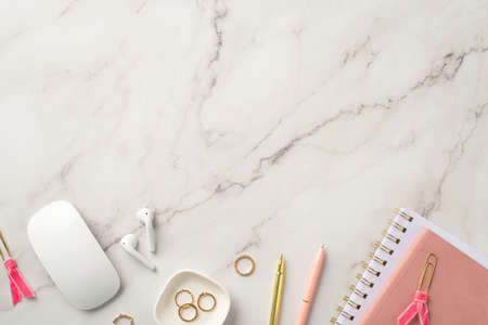 business concept. Top view photo of workstation pink note pads pens computer mouse gold rings clips...