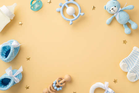 baby concept. Top view photo of blue teddy-bear toy rattle socks milk bottle teether soother knitted...