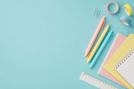 Back to school concept. Top view photo of school supplies stack of copybooks pens adhesive tape...